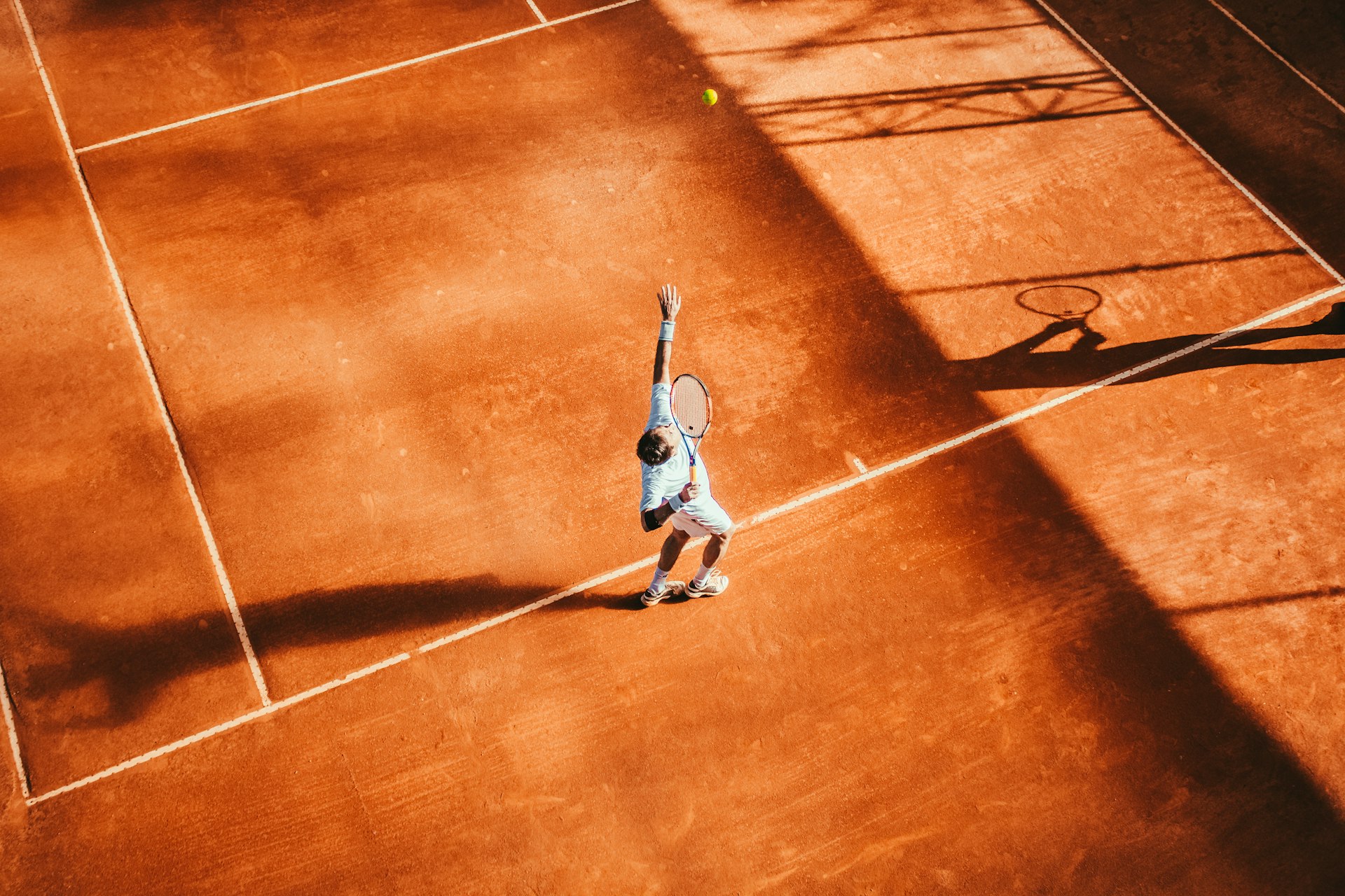 Racquet sport action on an indoor court